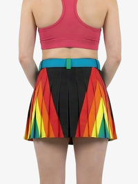Person wearing a colorful rainbow skirt with a plain background