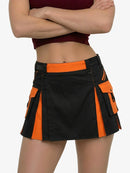 Black and orange skirt worn by a person on a white background
