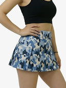Blue camouflage skirt worn by a person on a white background