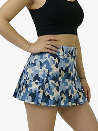 Blue camouflage skirt worn by a person on a white background