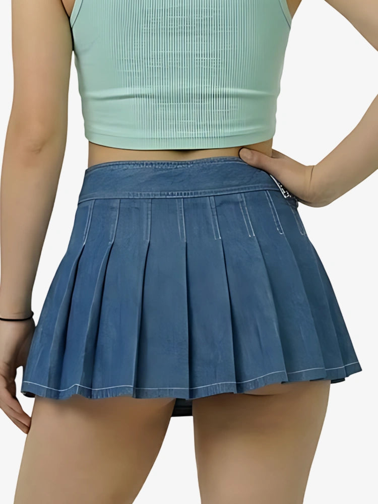 Person wearing a blue pleated skirt and light green crop top on a white background