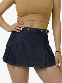 Person wearing a navy blue skirt with gold buttons on a white background
