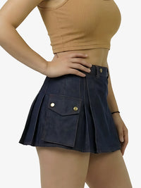 Person wearing a navy blue skirt with gold buttons on a white background