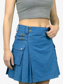 Person wearing a blue skirt with button details on a plain background