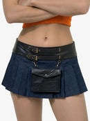 Person wearing a navy pleated skirt with a black leather belt and bag on a white background