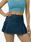 Person wearing a blue crop top and navy skirt on a white background
