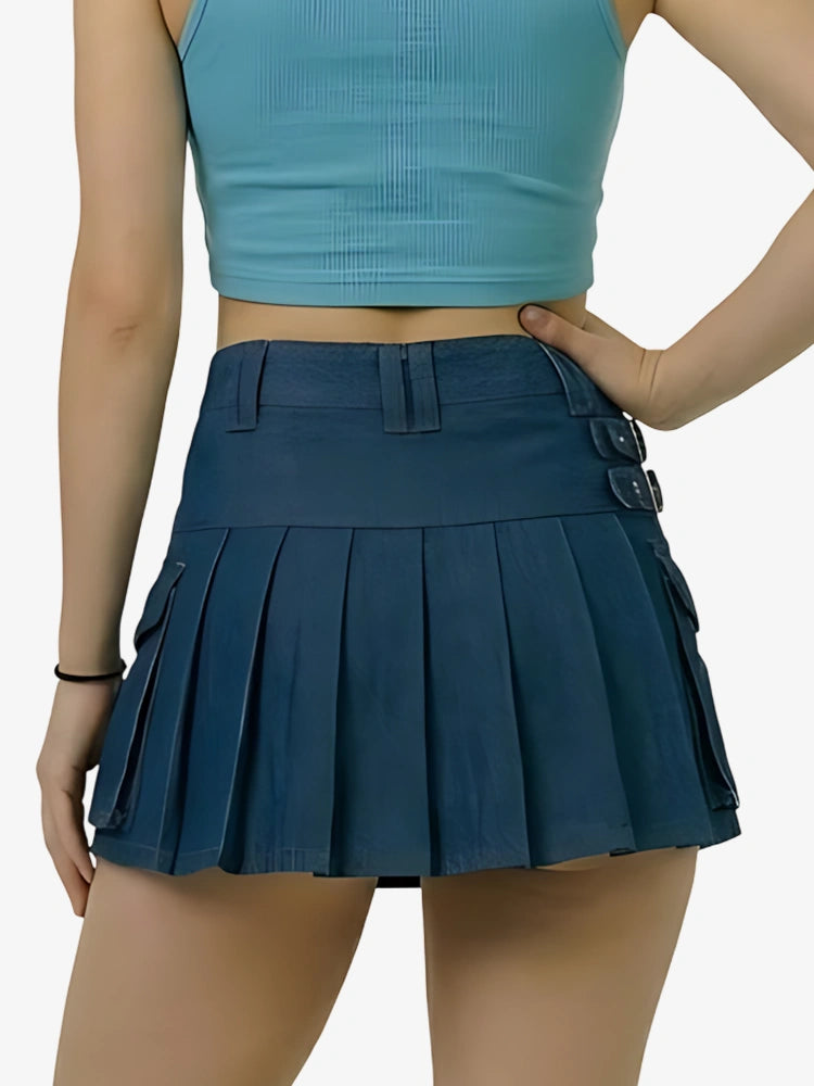 Person wearing a blue pleated skirt and crop top on a white background
