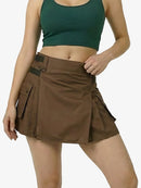 Woman wearing a green crop top and brown cargo skirt on a white background