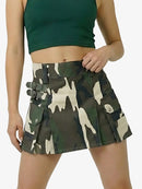 Person wearing a camouflage skirt with tactical details on a white background