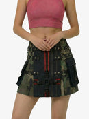 Person wearing a camouflage skirt with tactical design on a white background