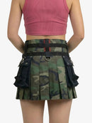 Camouflage pleated skirt with black accents worn by a person on a white background