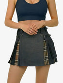 Person wearing a black kilt with plaid accents on a white background