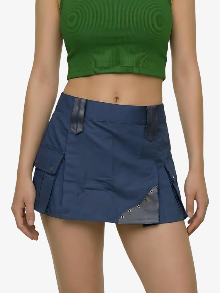 Person wearing a blue skirt with a green top on a plain background