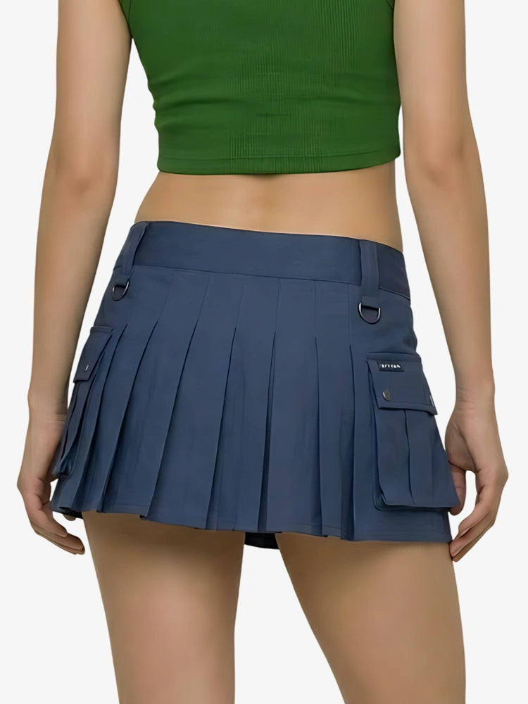 Person wearing a green crop top and blue pleated skirt on a white background