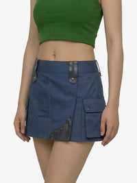 Person wearing a green top and blue skirt on a white background