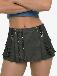 Person wearing a dark gray skirt with gold buttons and hardware on a white background