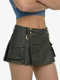 Person wearing a dark green skirt with button details on a white background