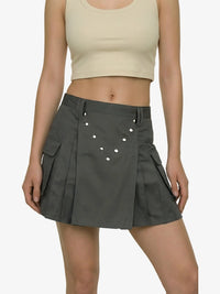 Person wearing a gray skirt with a plain background