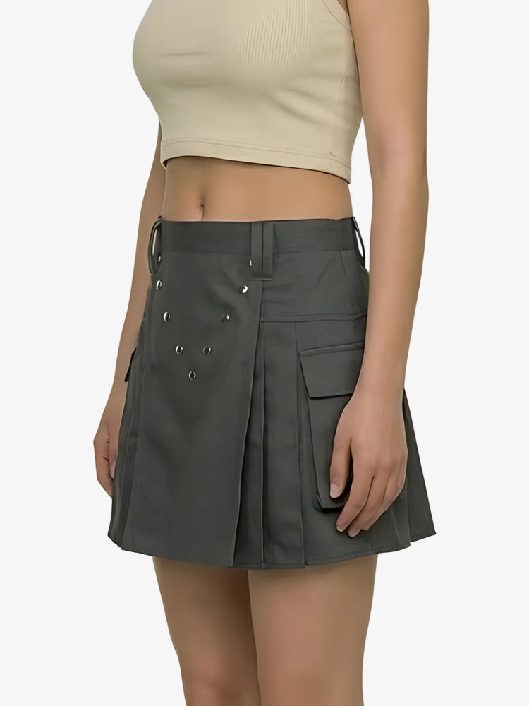 Person wearing a gray pleated skirt on a white background