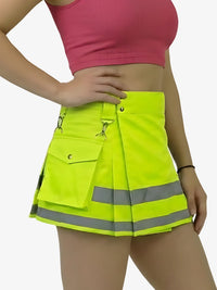 Person wearing a bright yellow safety skirt with reflective stripes on a white background
