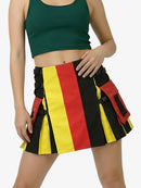 Person wearing a green crop top and a colorful striped skirt with black straps on a white background