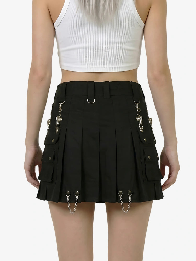 Black pleated skirt with gold chain details worn by a person on a white background