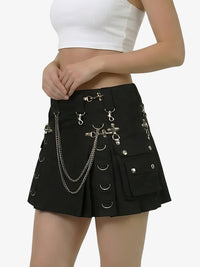 Black skirt with chain details worn by a person on a white background
