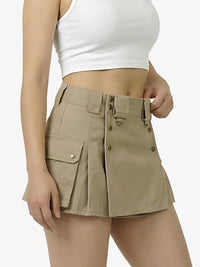 Person wearing beige shorts with button details on a white background