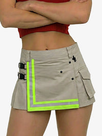 Person wearing a beige cargo skirt with reflective green trim on a white background