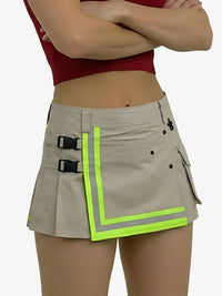 Beige skirt with reflective green trim worn by a person on a white background