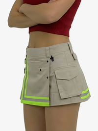 Person wearing a beige cargo skirt with reflective green stripes on a white background