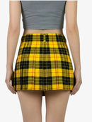 Yellow plaid skirt worn by a person on a white background