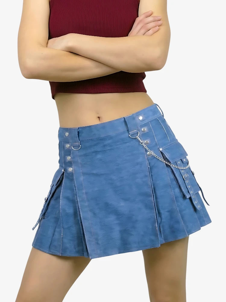 Person wearing a blue denim skirt with decorative elements on a white background