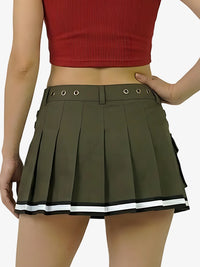Green pleated skirt with white trim worn by a person on a white background