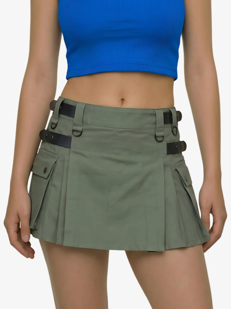 Person wearing a green skirt with black straps on a white background