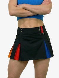 Person wearing a black skirt with colorful side panels on a white background