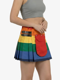 Person wearing a rainbow-colored pleated skirt with a red pocket on a white background
