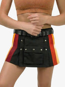 Person wearing a black skirt with red and yellow accents on a plain background