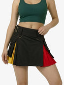 Woman wearing a black, red, and yellow skirt with a green top on a white background