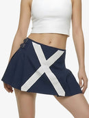 Navy blue skirt with a large white 'X' design worn by a person on a plain background