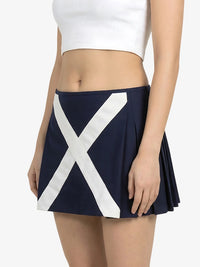 Navy blue skirt with a large white 'X' design worn by a person on a white background