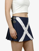 Navy blue skirt with white cross design worn by a person on a white background