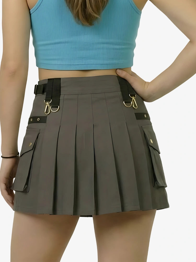 Person wearing a gray pleated skirt with black straps and gold buckles on a white background