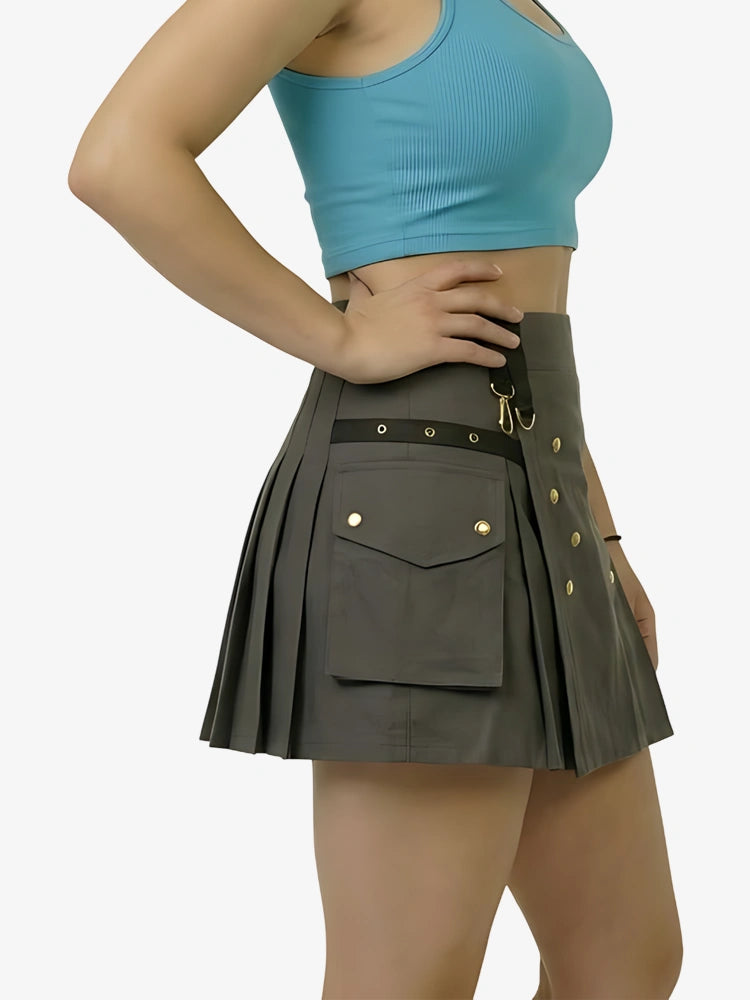 Person wearing a gray pleated skirt with gold buttons on a white background