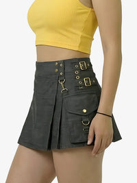 Person wearing a black skirt with gold buttons and a yellow top on a white background