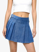 Blue denim skirt worn by a person on a white background