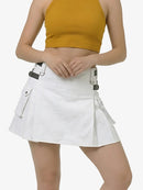 Person wearing a white skirt with black straps on a plain background