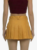 Yellow pleated skirt worn by a mannequin on a white background