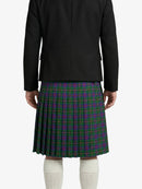 Person wearing a black jacket and green plaid kilt on a white background