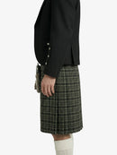 Person wearing a black jacket and plaid kilt on a white background